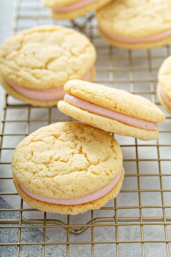 Sandwich cookies with raspberry buttercream in the center.