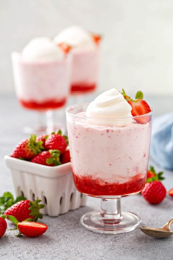 Strawberry Mousse in three glass jars.