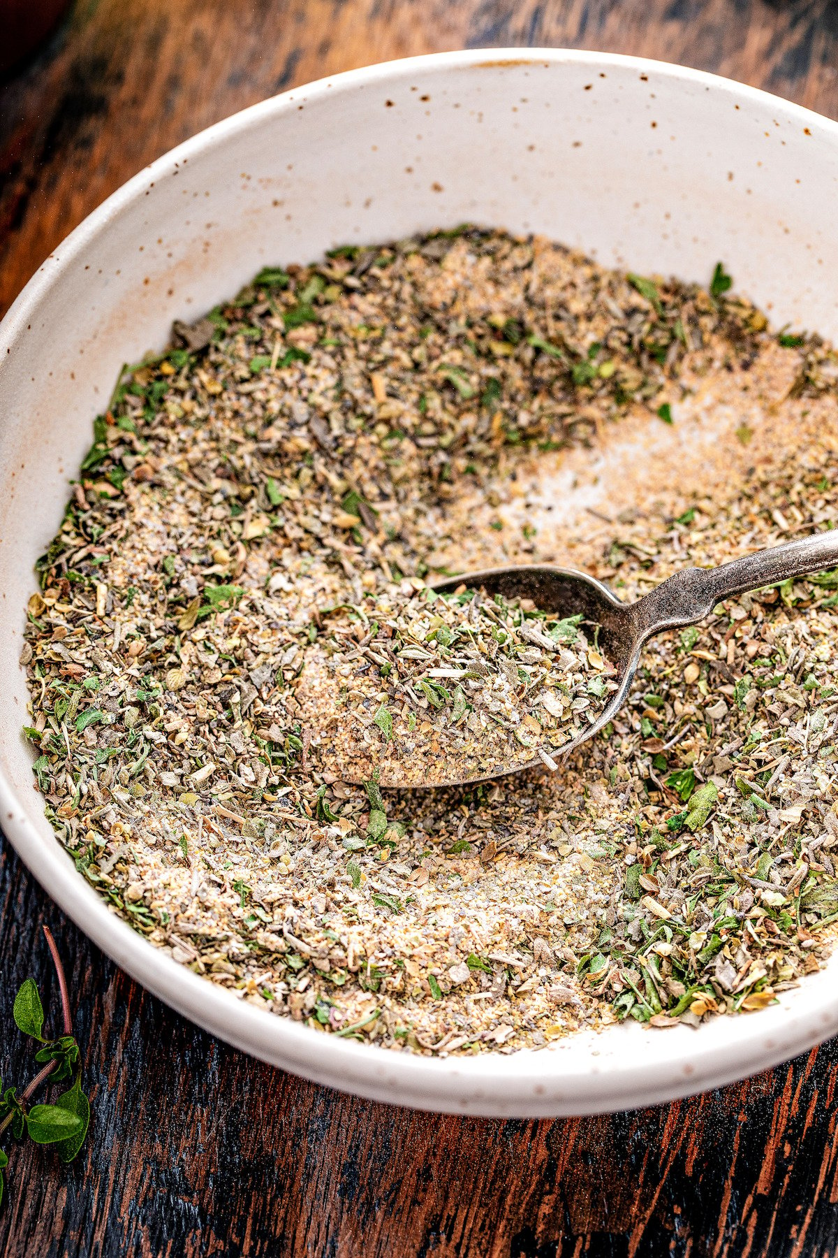 Shallow bowl filled with dried herbs and spices.