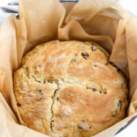 Irish Soda Bread in parchment paper and pot after baking.