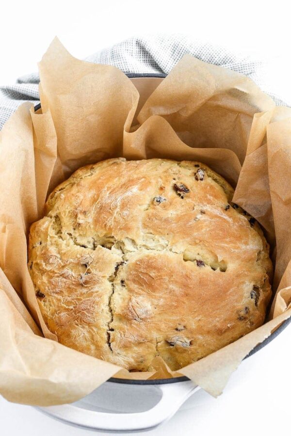 Irish Soda Bread in parchment paper and pot after baking.