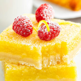 These deliciously sweet and tart Lemon Bars are made fully from scratch with a buttery shortbread crust and an extra thick layer of perfectly tart lemon filling! #LemonBars #LemonBarRecipe #LemonRecipes #CitrusRecipes #Lemon #BarRecipes #DessertRecipes #SummerRecipes #LemonDesserts #LemonDessertRecipes