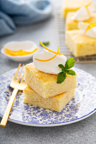 Slices of orange coconut cake on a blue plate.