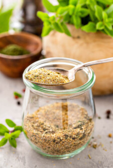 Spoon and jar with Homemade Greek Seasoning