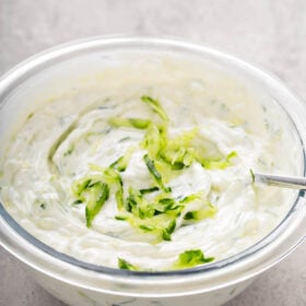 Cucumber dip in a bowl with a spoon