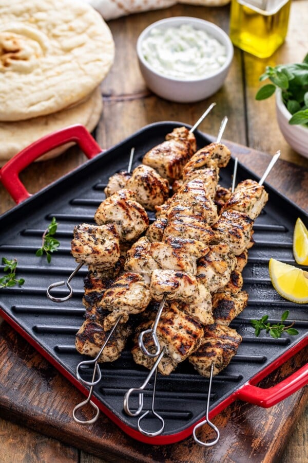 Grilled chicken skewers on a grill pan.