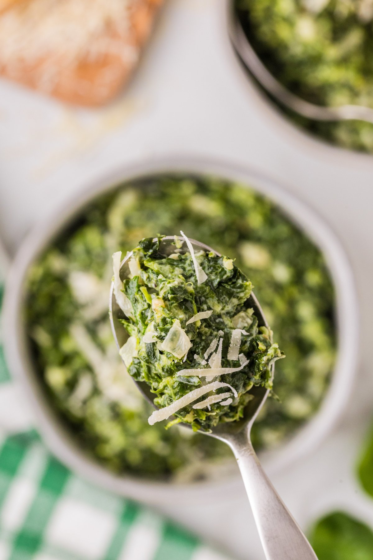 A spoonful of creamy spinach with parmesan. 