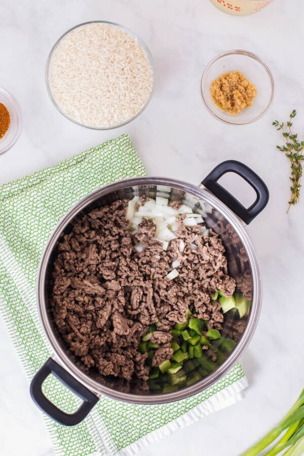 Ground meat in pot with vegetables. 