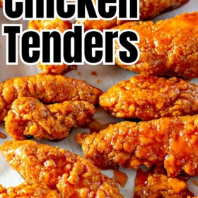 A large batch of crispy, saucy chicken tenders are spread out on a white surface.