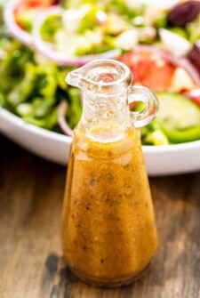 Greek salad dressing in a glass bottle.