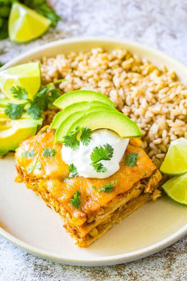 Mexican casserole on a plate with brown rice.