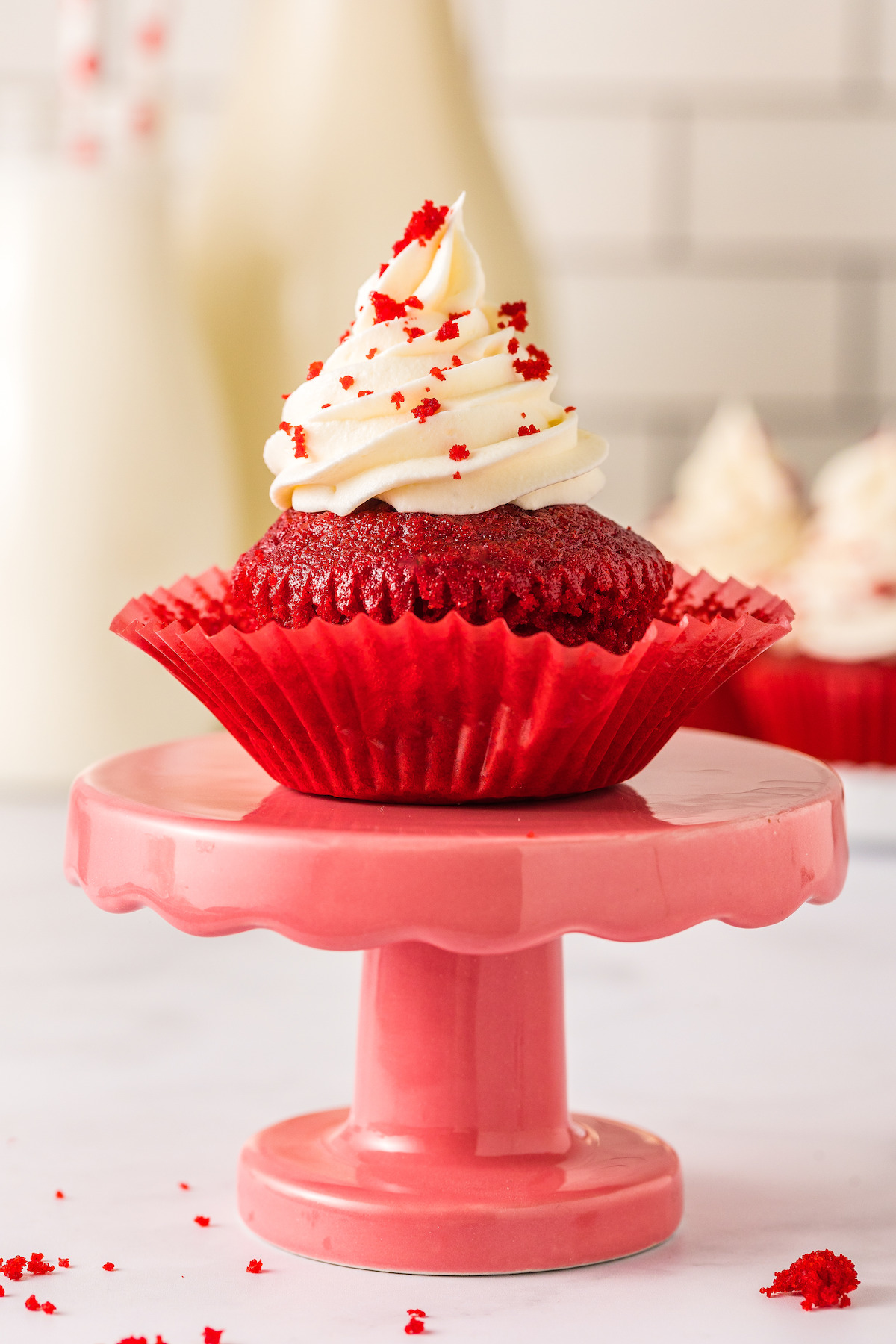 Unwrapped cupcake with cream cheese frosting.