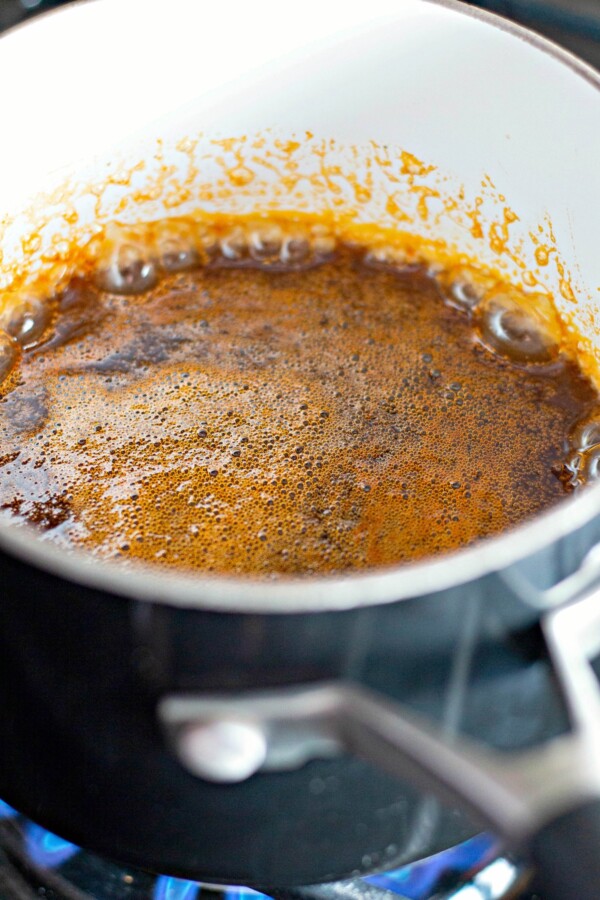 Sweet and spicy sauce is cooking in a pot. 