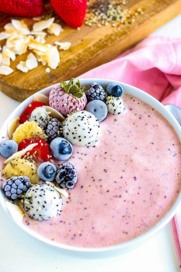 Strawberry smoothie bowl with mixed berry toppings
