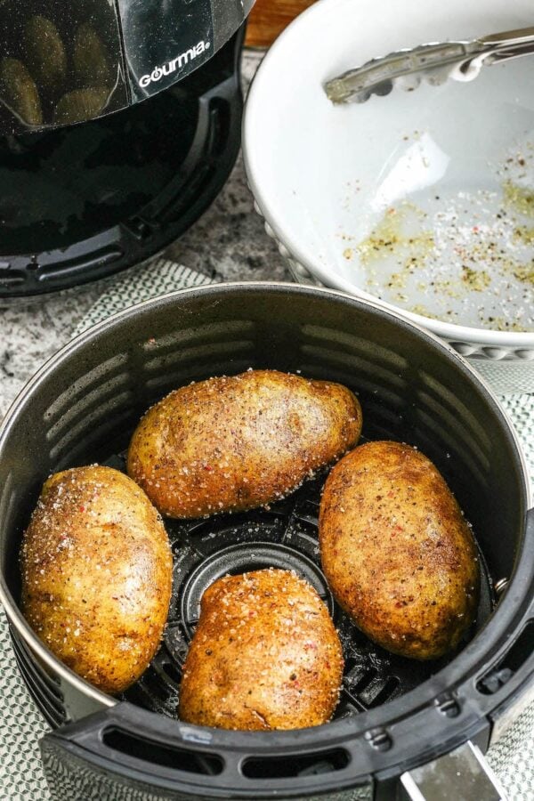 Baked Potatoes in Air Fryer basket. 