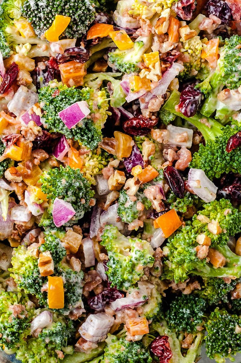 Up close image of a fresh vegetable salad with broccoli, onion, bacon and more. 
