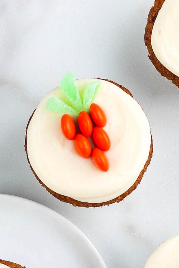 Carrot cake cupcakes with decoration on top.