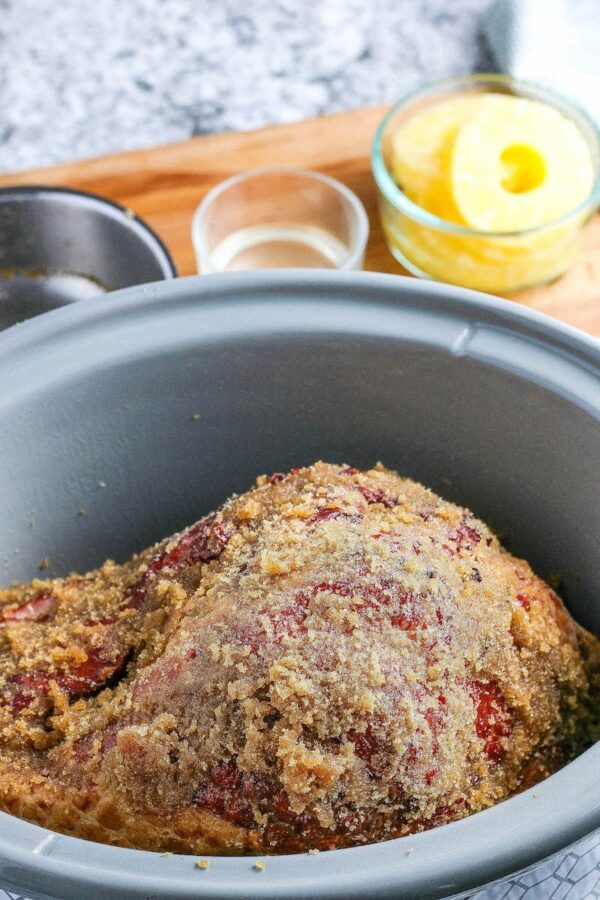 Ham in crockpot with glaze on top.