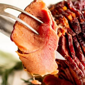 Slice of slow cooker ham with pineapple glaze.