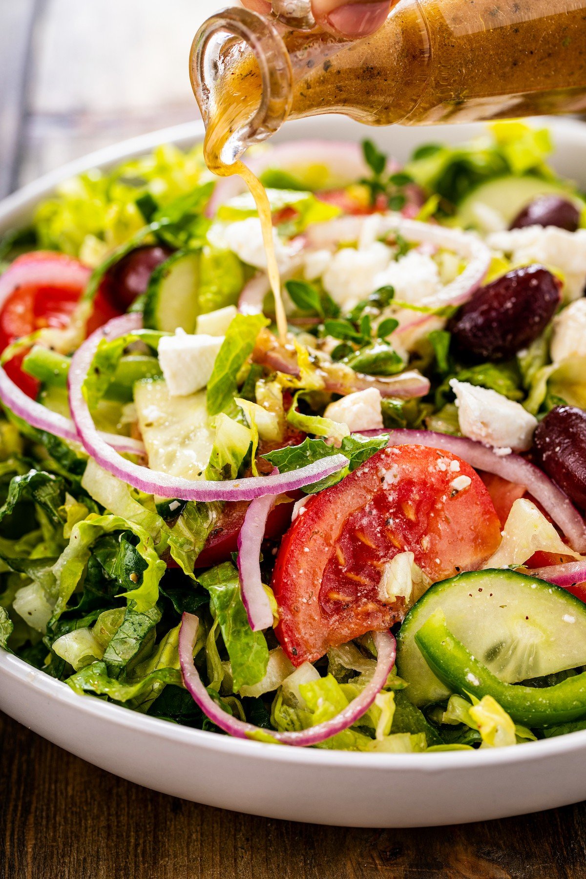 Tomatoes, cucumbers, lettuce, feta cheese, and red onion topped with Greek salad dressing.