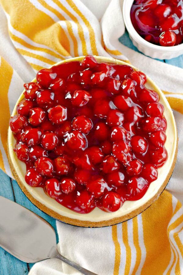 A top view of the cheesecake topped with cherry pie filling.