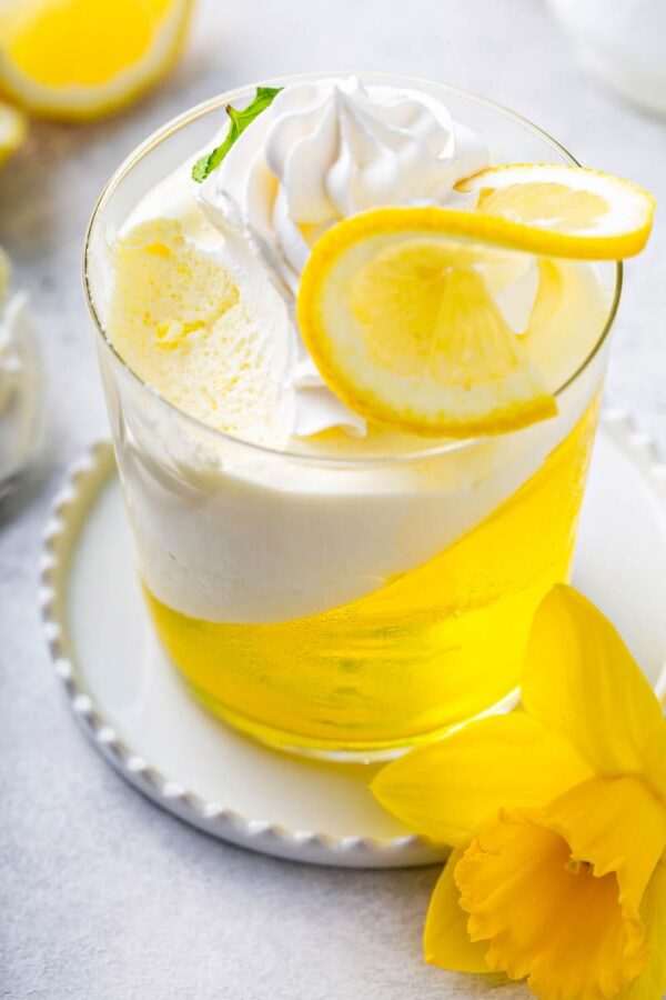 Lemon Mousse Jello Cups with a bite taken out of the top. 