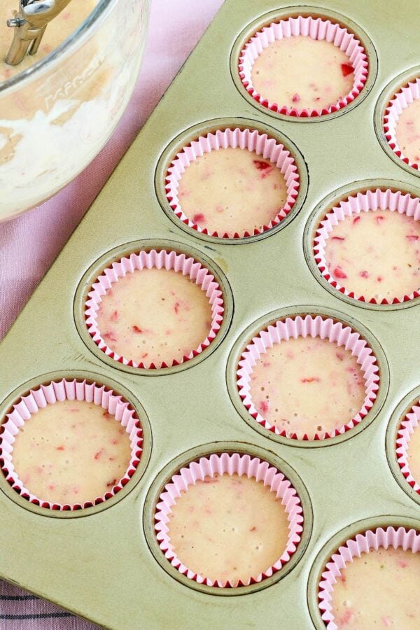 Strawberry cupcake batter in the foils ready to be baked.