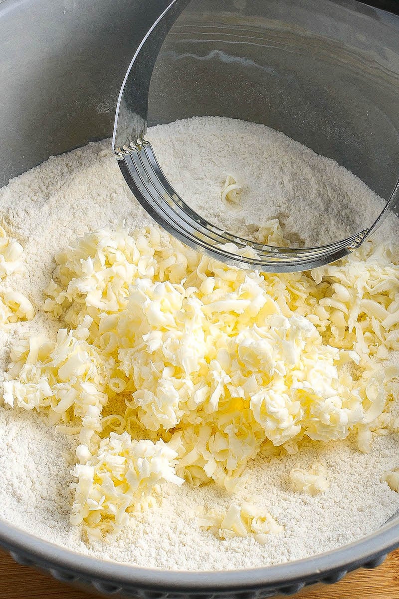 Frozen grated butter being worked into the flour.