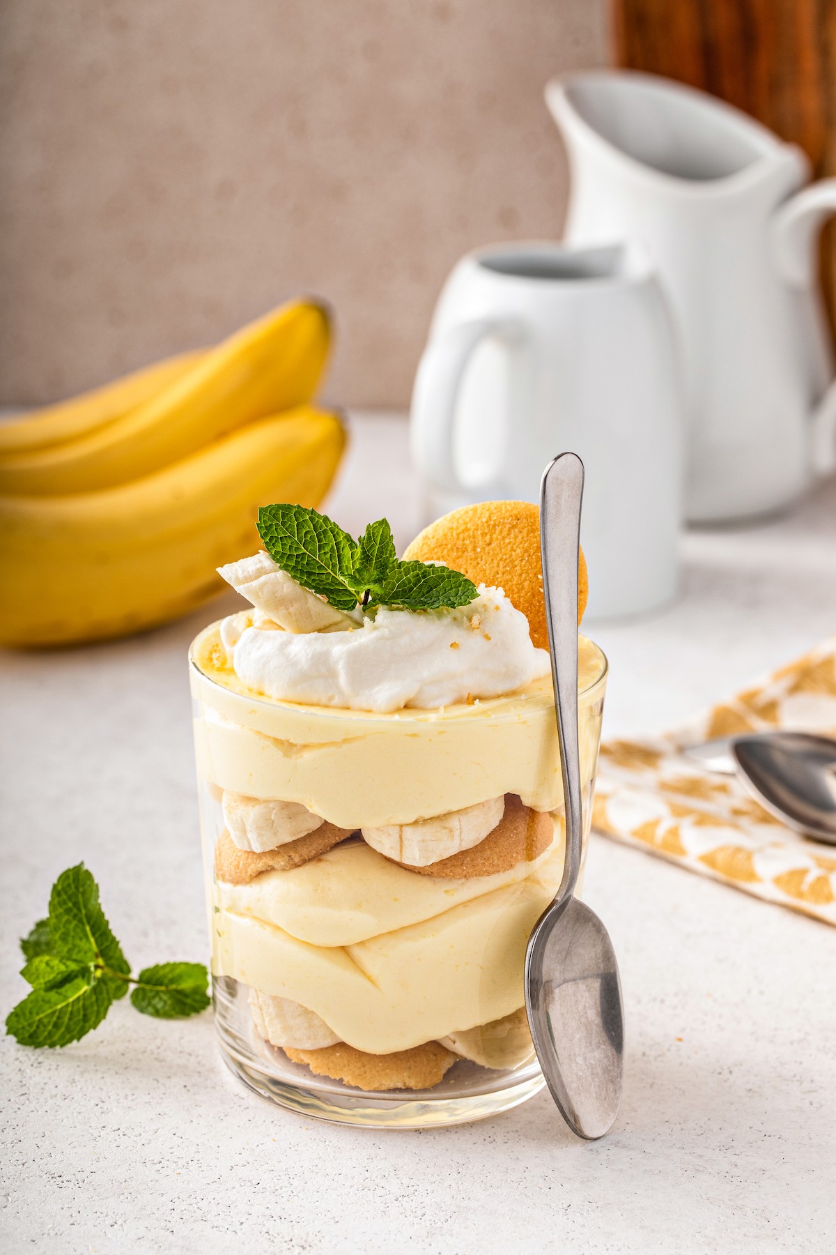 A personal homemade banana pudding with a spoon leaning against the dish