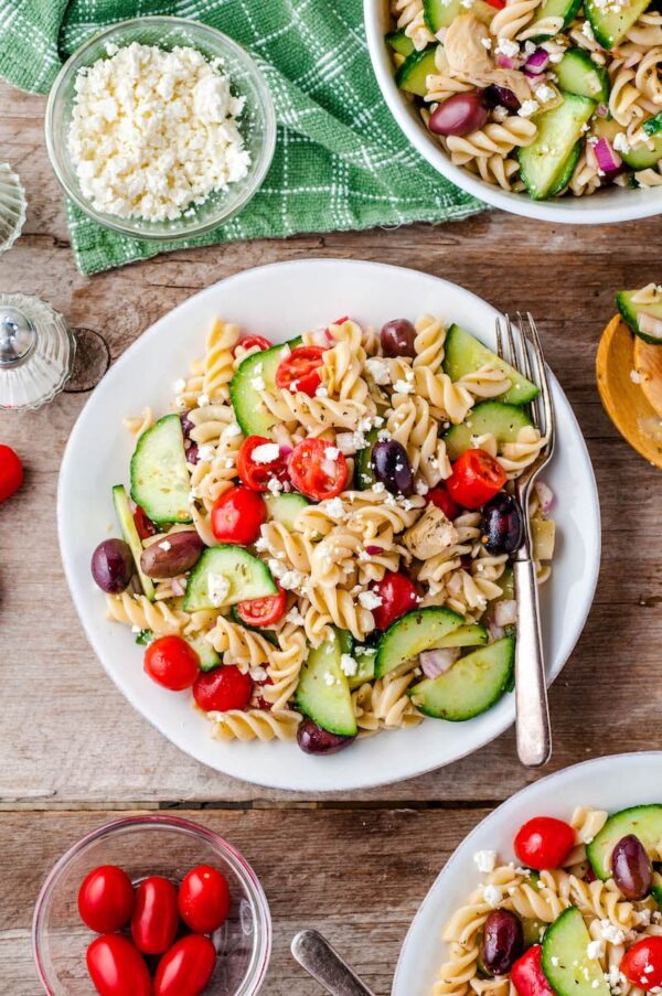 A bowl of Greek pasta salad with a fork. 