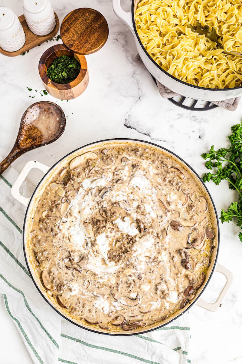 A baking pan filled with sauce and heavy cream.