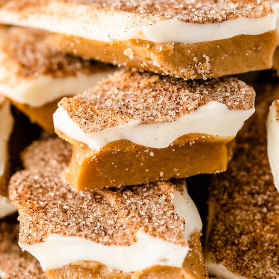 Close up shot of cinnamon sugar toffee with white chocolate staked on top of each other.