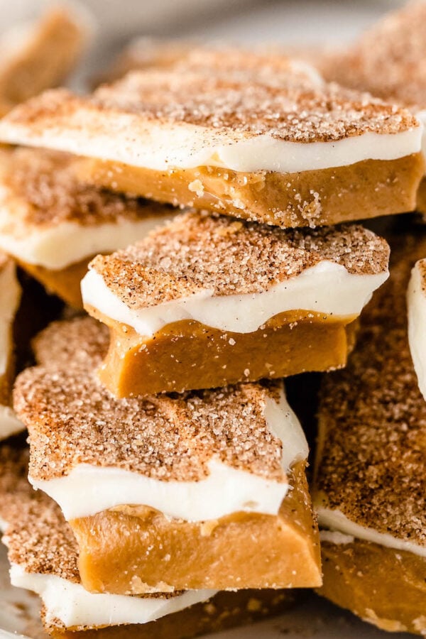 Close up shot of cinnamon sugar toffee with white chocolate staked on top of each other.