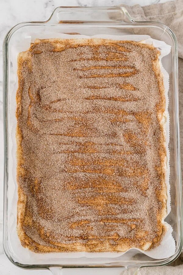 Cinnamon sugar dusted over the toffee in a baking dish.