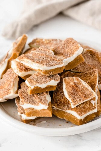 Cinnamon sugar toffee on a white plate with a napkin.