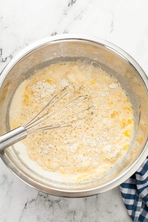 Dry ingredients are being mixed into wet batter.