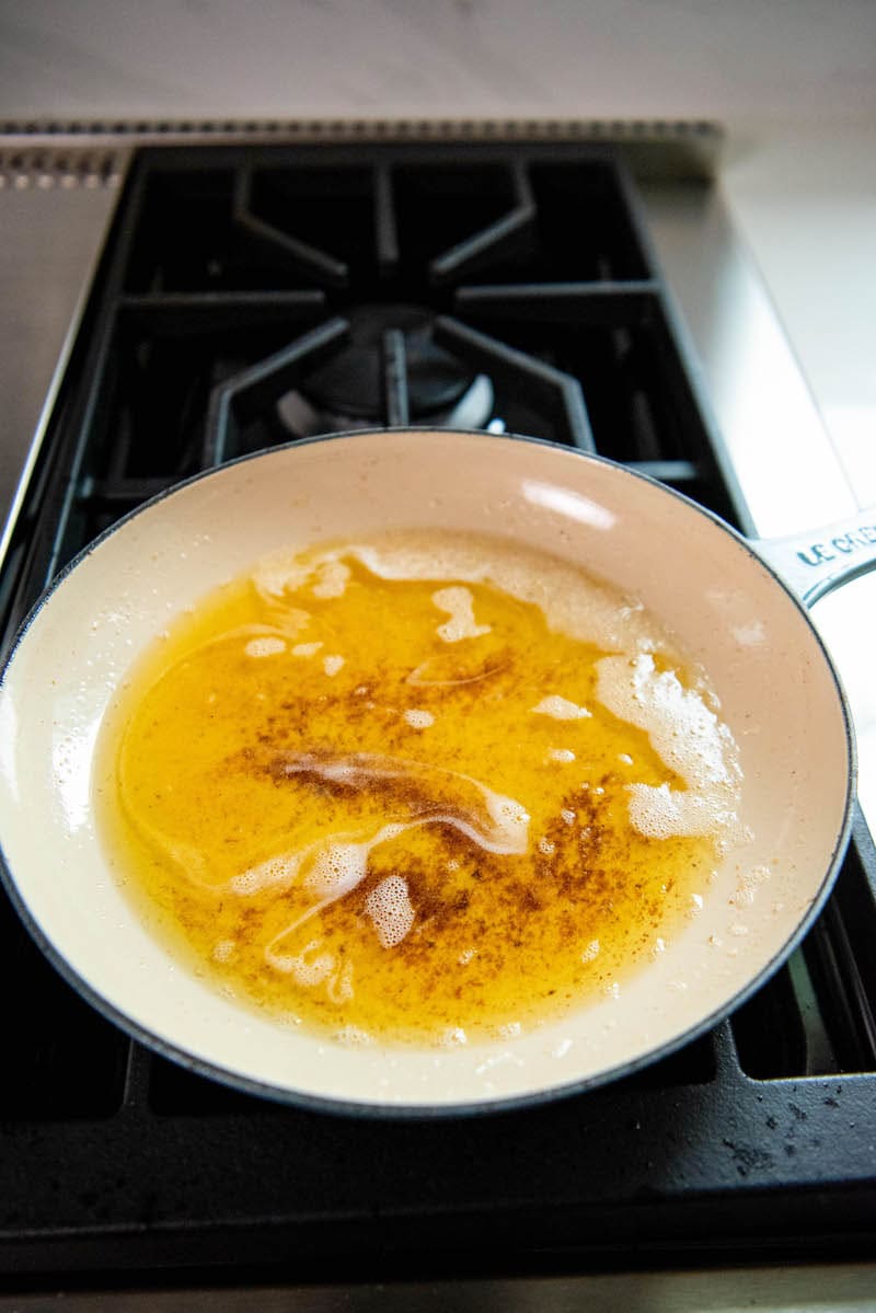 Brown butter in a skillet on a stove top.