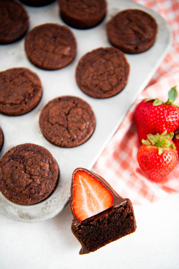 Chocolate Covered Strawberry Brownie Bite with brownie bites behind it. 