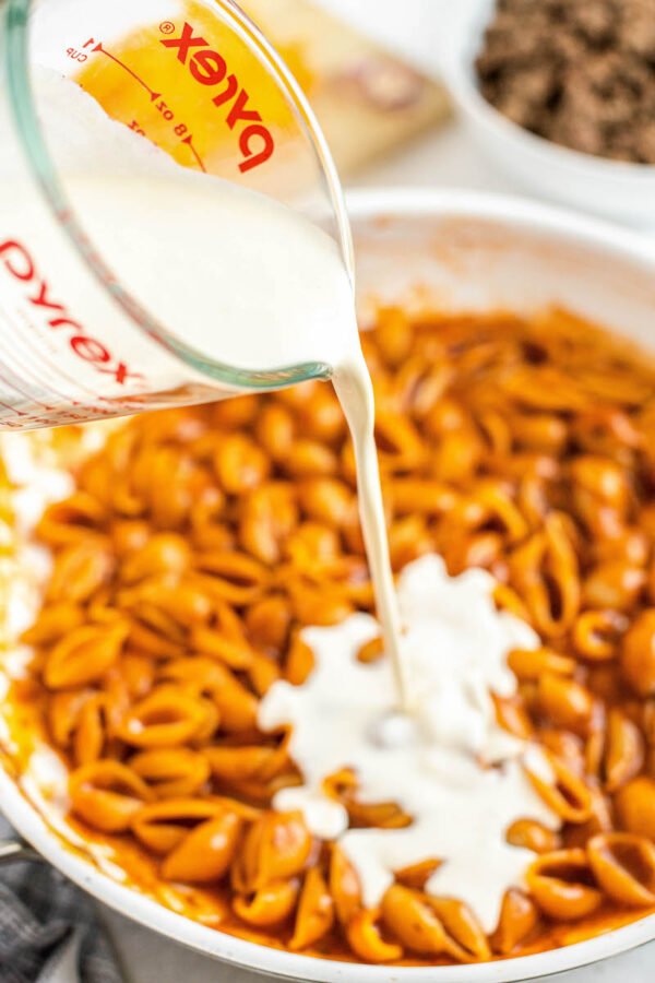 Pouring Cream into Pasta