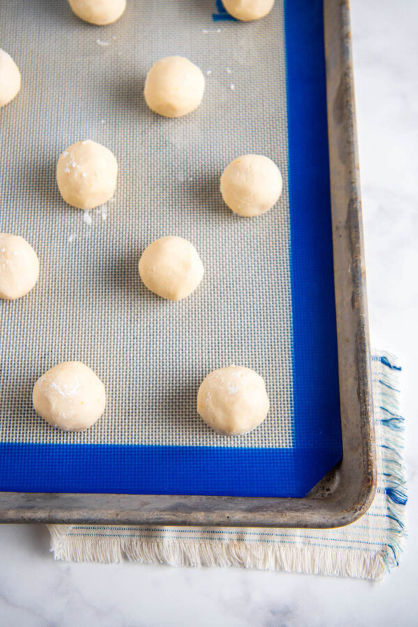 Cookie sheet filled with shortbread dough balls.
