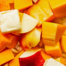 Close-up of cubed butternut squash and apples with butter