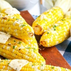 Grilled ears of corn with butter and fresh herbs