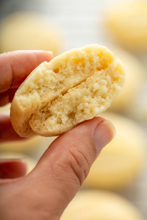 Lemon whipped shortbread cookie broken in half to see the inside.