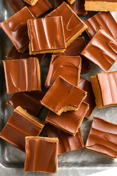 A pan full of chocolate peanut butter bars cut into squares.