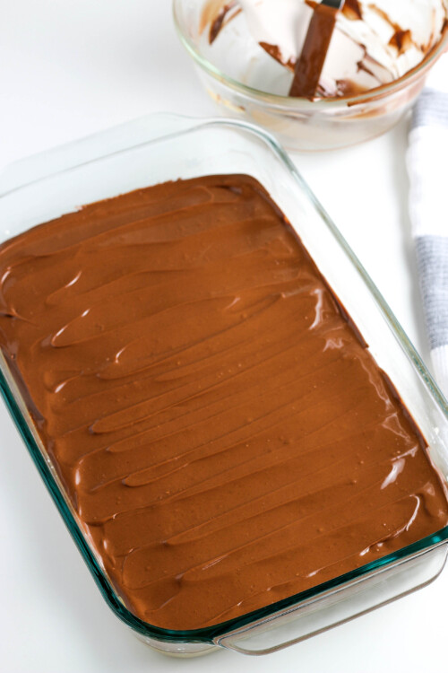 Pan of peanut butter mixture with chocolate on top.