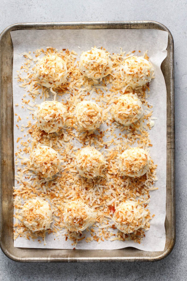 Pina Colada Truffles on a baking sheet with parchment paper.