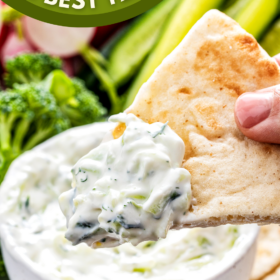 Pita bread with tzatziki sauce on it.