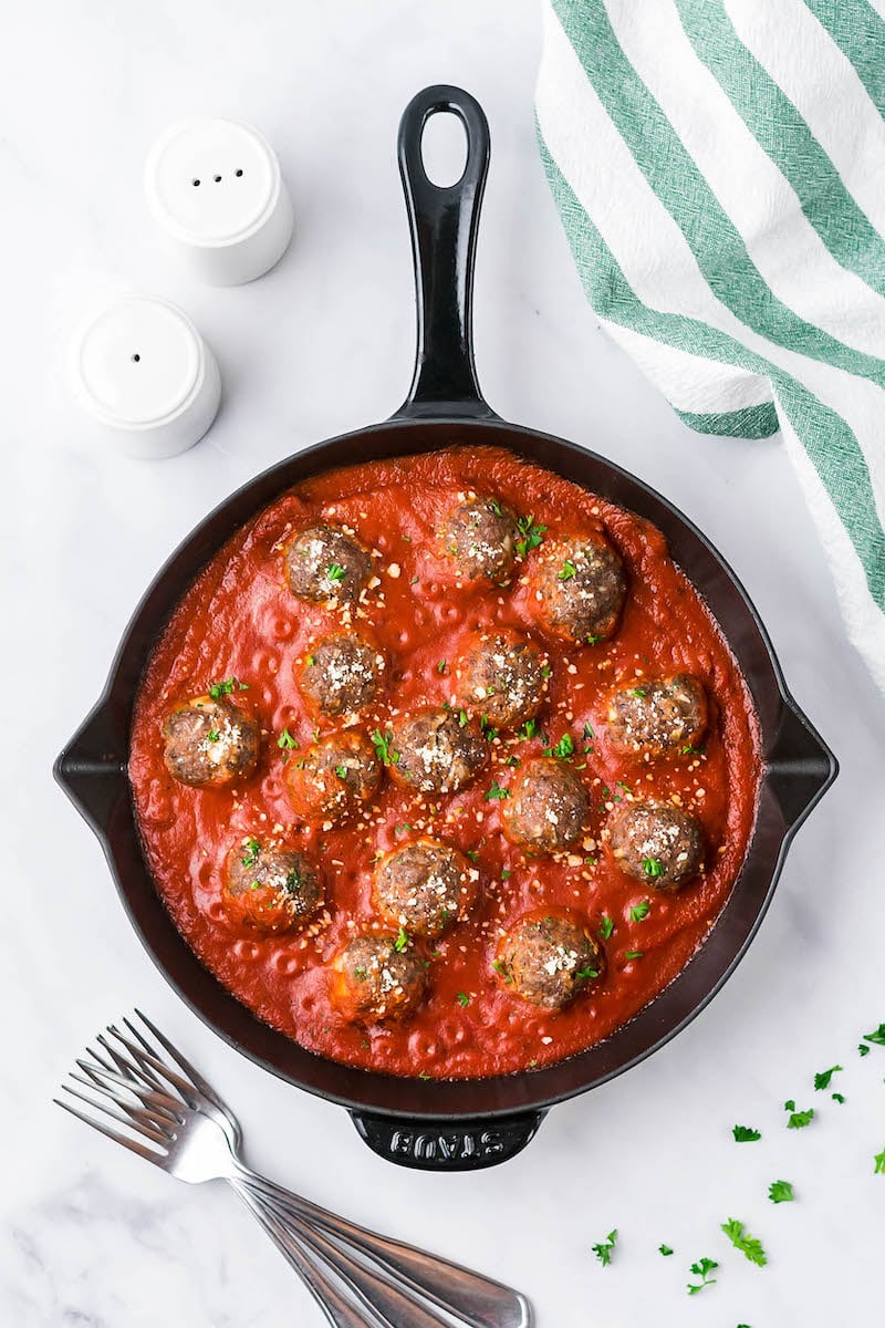 Meatballs in a pan with tomato sauce.