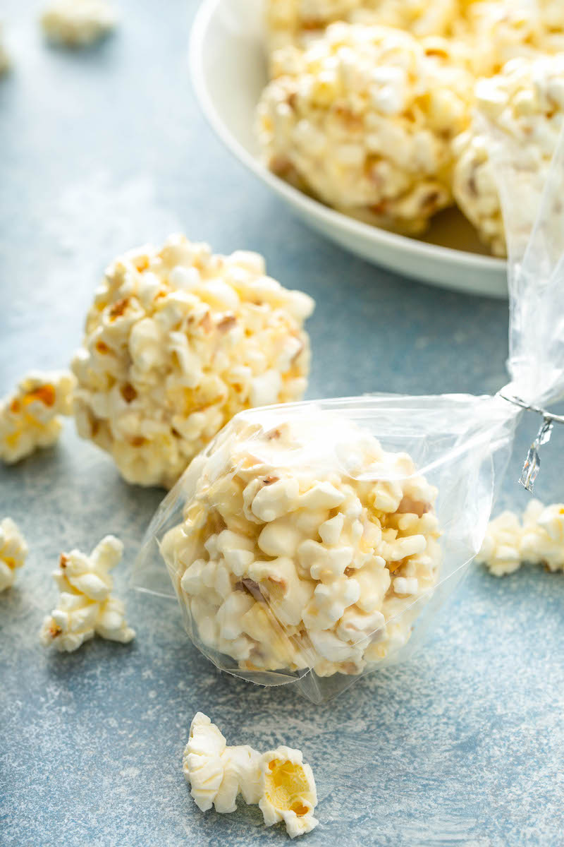 A popcorn ball is wrapped in plastic wrap