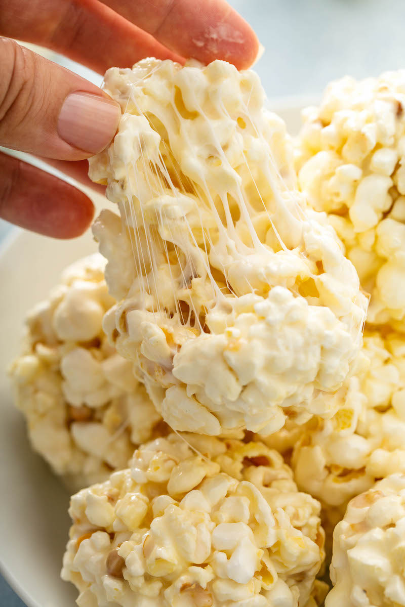 Popcorn being pulled apart to show the marshmallow inside. 